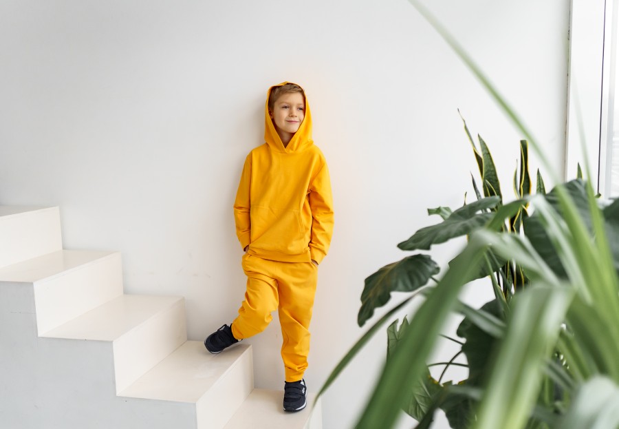 teenager-yellow-tracksuit-monochrome-background-hood.jpg