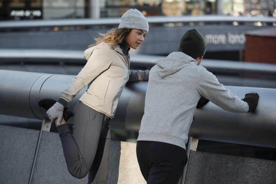 medium-shot-man-woman-stretching.jpg