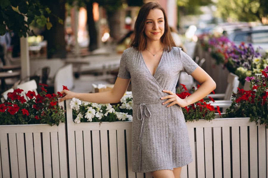 portrait-happy-woman-outside-cafe-decorated-with-flowers.jpg