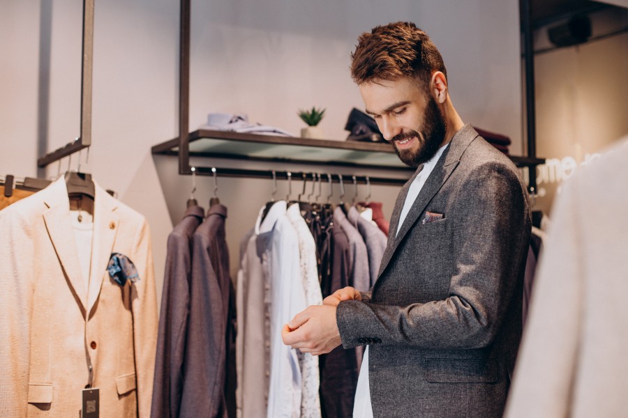young-man-choosing-cloths-menswear-shop.jpg