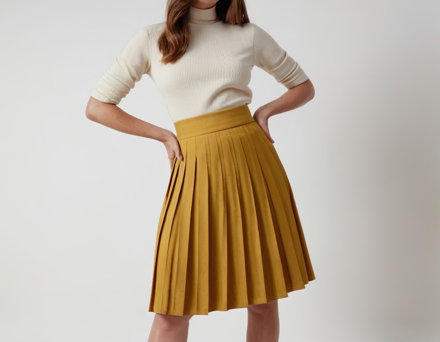 stylish-woman-with-shoulderlength-hair-wearing-cream-sweater-mustard-pleated-skirt.jpg