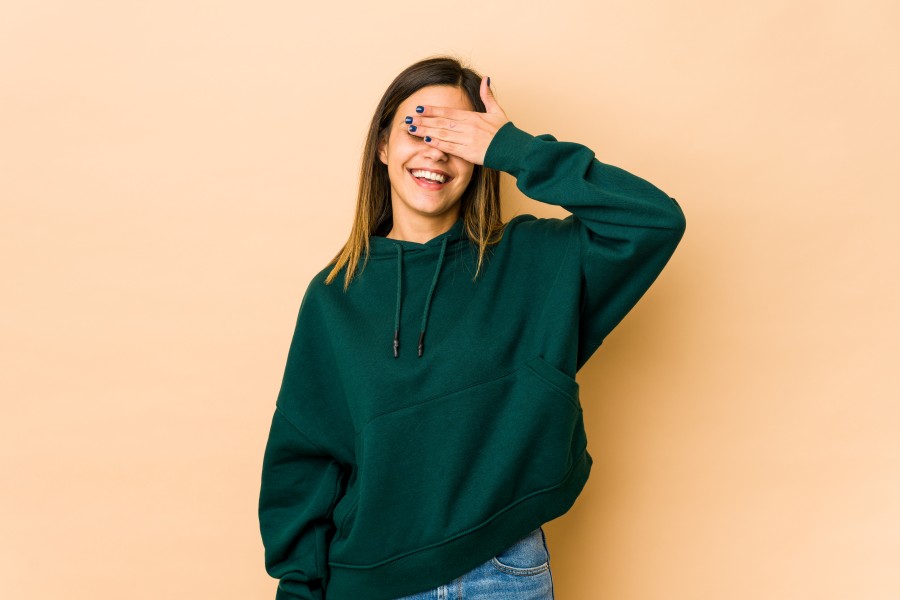 young-woman-isolated-beige-covers-eyes-with-hands-smiles-broadly-waiting-surprise.jpg