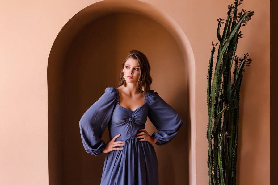 young-brunette-girl-casual-blue-dress-posing-beige-room.jpg