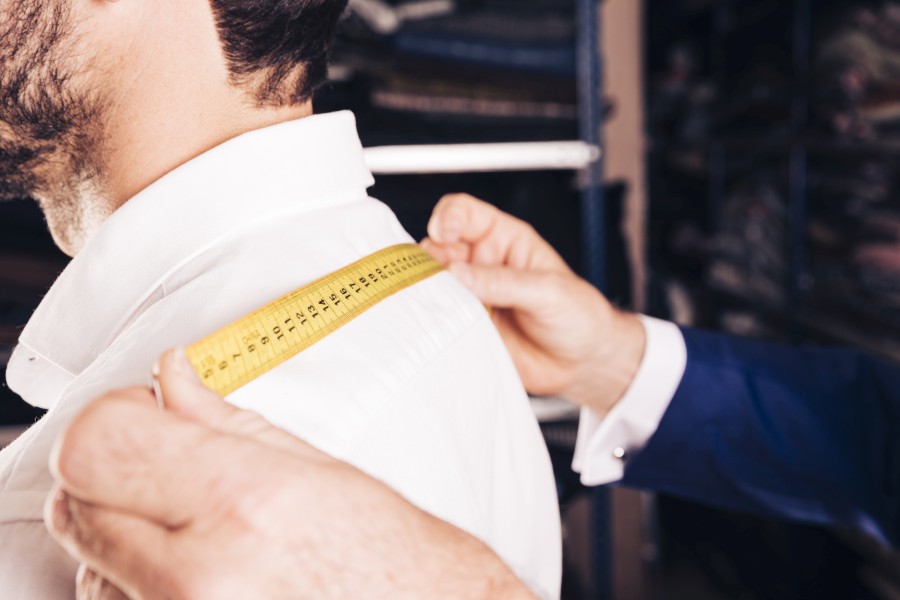 fashion-designer-taking-measurement-his-customer-s-back-with-yellow-measuring-tape.jpg