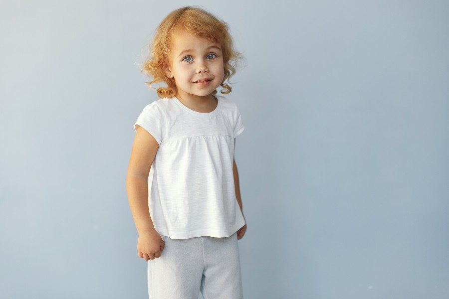 cute-little-girl-sitting-studio-blue-background.jpg