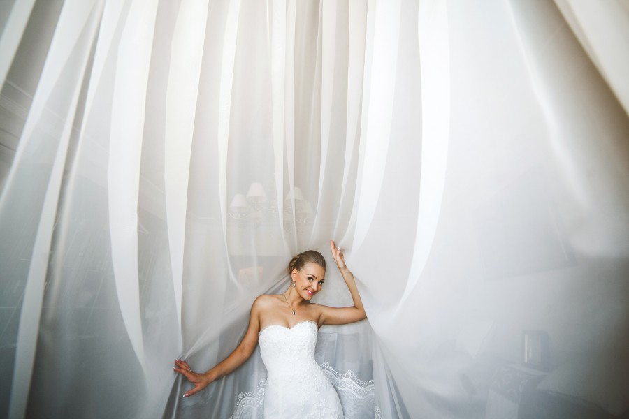 bride-posing-with-white-curtains.jpg