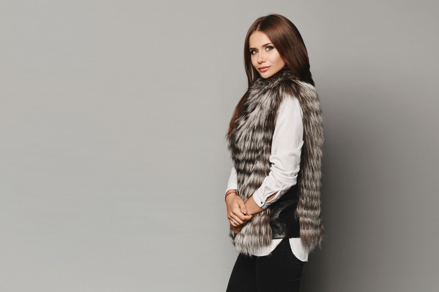 side-view-young-model-woman-trendy-winter-fur-vest-posing-grey-background-isolated-winter-fashion.jpg