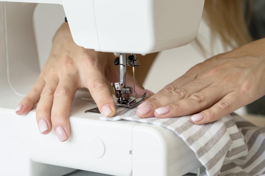 woman-sewing-textile-with-machine.jpg