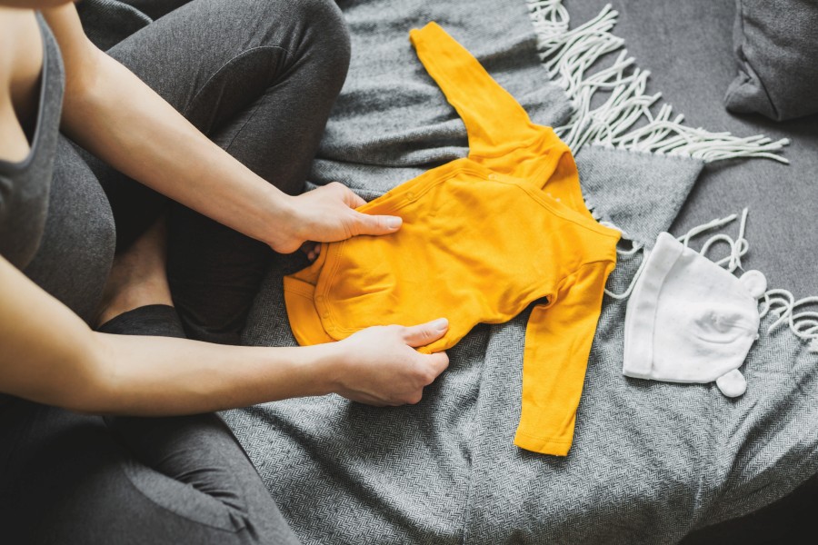 young-woman-preparing-clothes-baby.jpg
