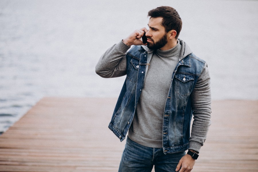 good-looking-bearded-man-by-river-park-using-phone.jpg
