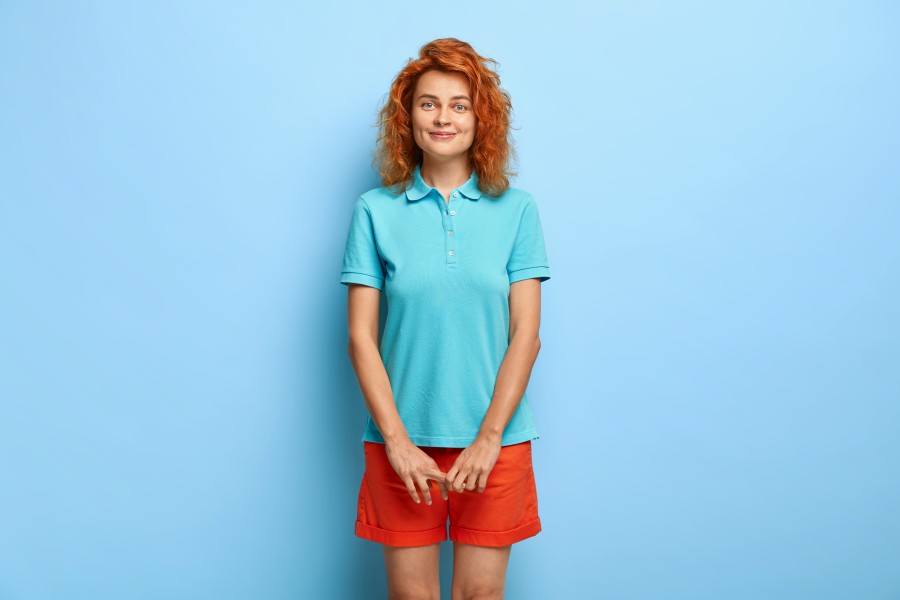 modest-lovely-teenage-girl-with-wavy-red-hair-has-satisfied-facial-expression-wears-casual-blue-t-shirt-shorts.jpg