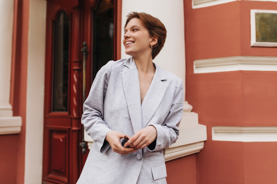 adorable-woman-grey-jacket-smiling-posing-outside-short-haired-lady-stylish-suit-laughing-leaning-wall.jpg