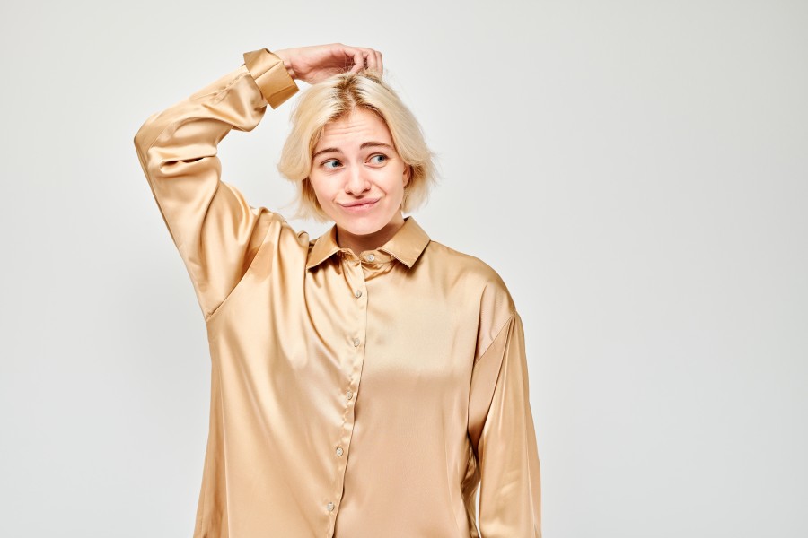 confused-young-woman-scratching-her-head-wearing-satin-blouse-isolated-light-background.jpg