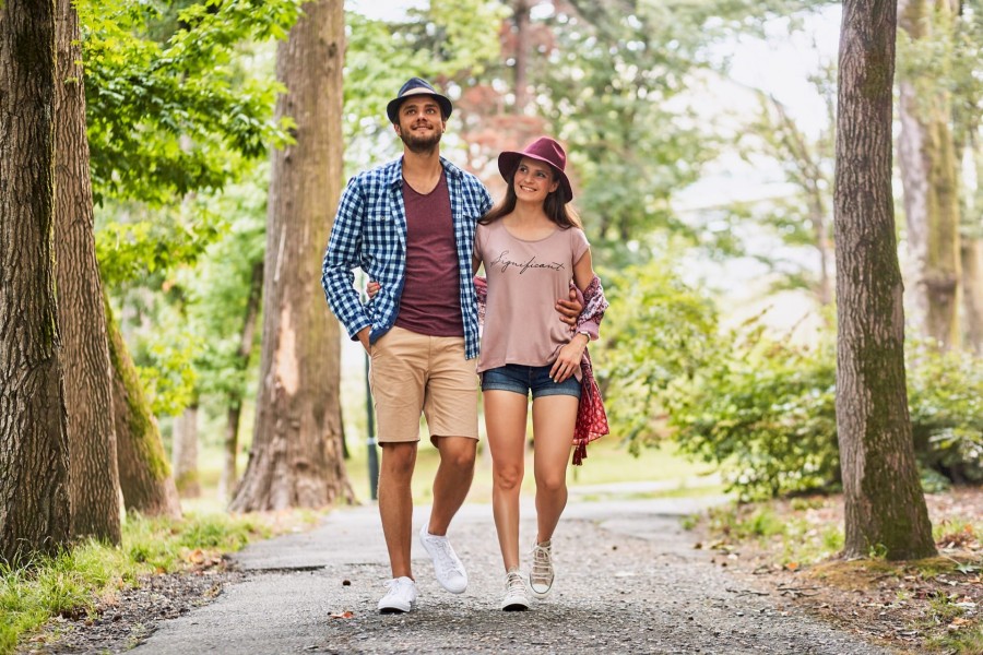 young-couple-walking-on-pathway-through-grass-field.jpg