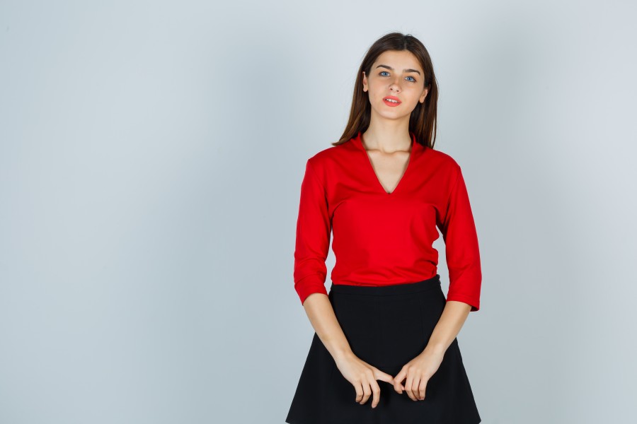 young-lady-holding-hands-front-her-red-blouse-black-skirt-looking-pretty.jpg